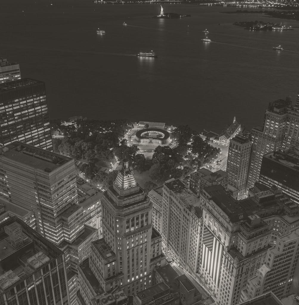 Lower Manhattan at night looking south over Battery Park to the harbour and the Statue of Liberty
